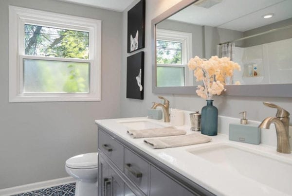 Bathroom with double sinks and large mirror